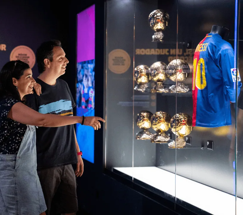 Visitors viewing shirts and trophy displays at the Barça museum