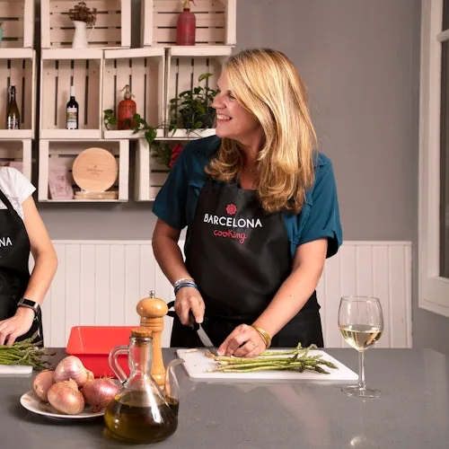 Cooking instructor beside ingredients in a Barcelona kitchen