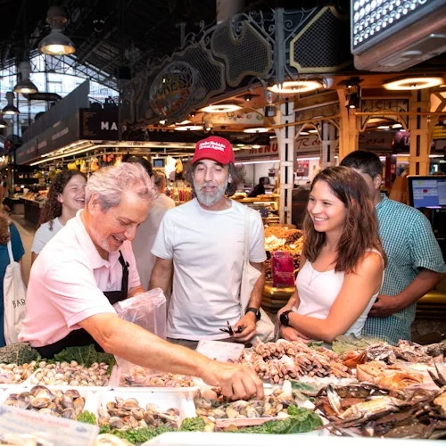 Cooking-class guests looking at a seafood market counter