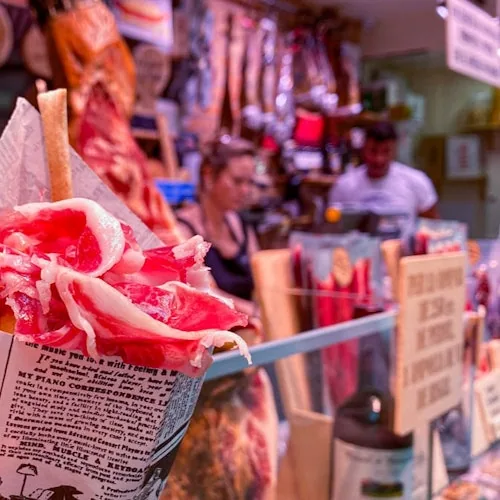 Cone of cured meat pictured at a Barcelona market counter