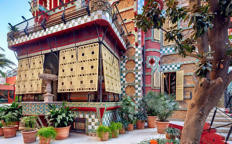 Green and cream tiles around a Casa Vicens window and terrace