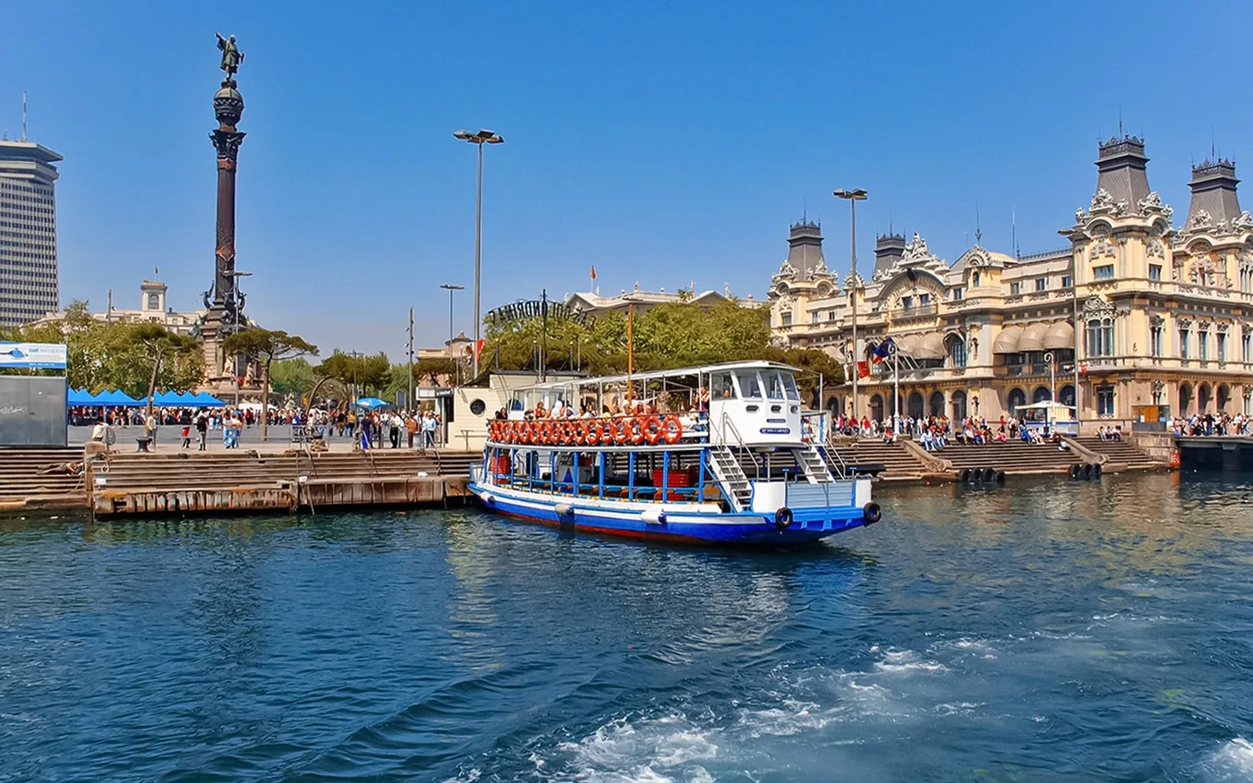 Las Golondrinas boat beside the Columbus Monument in Barcelona harbour