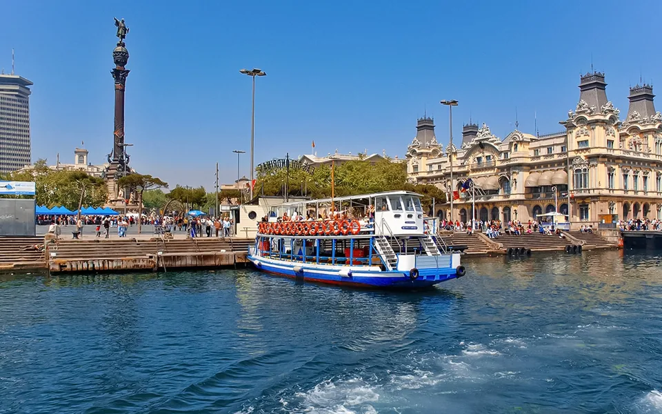 Las Golondrinas boat beside the Columbus Monument in Barcelona harbour