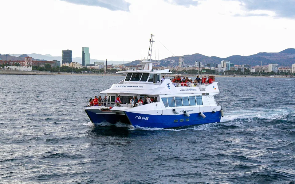 Blue and white sightseeing boat on the Barcelona waterfront