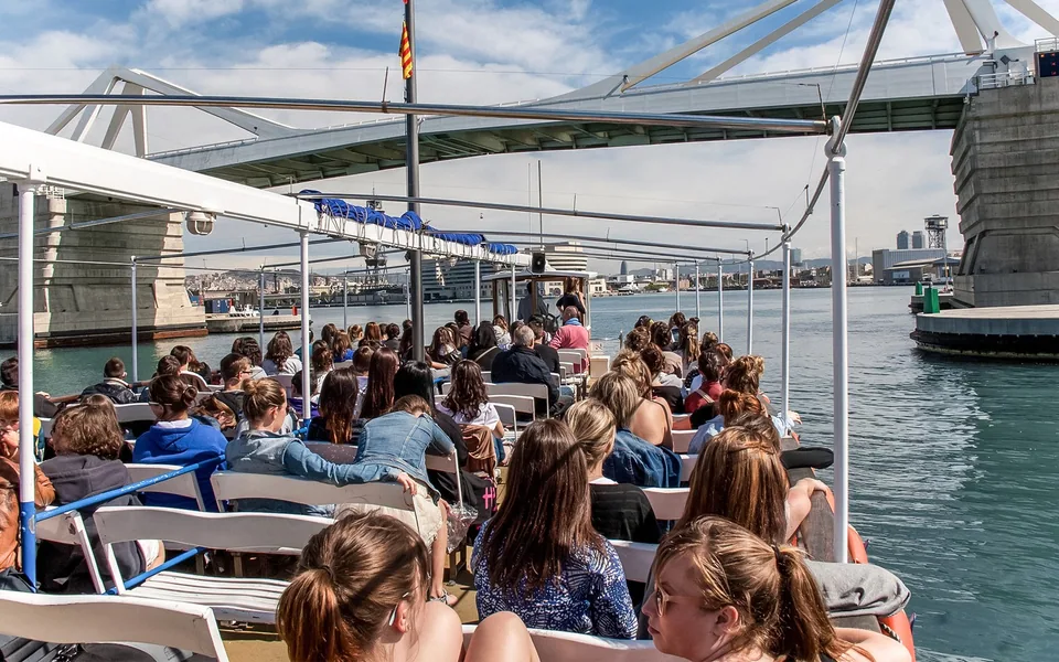 Passengers seated aboard a Barcelona harbour sightseeing boat