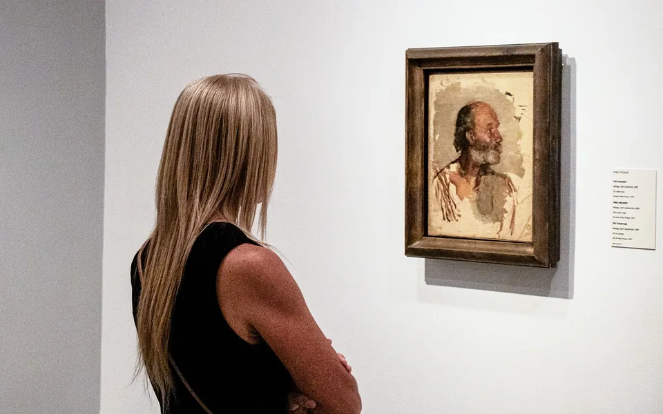 Visitor looking at a portrait painting in a Barcelona museum