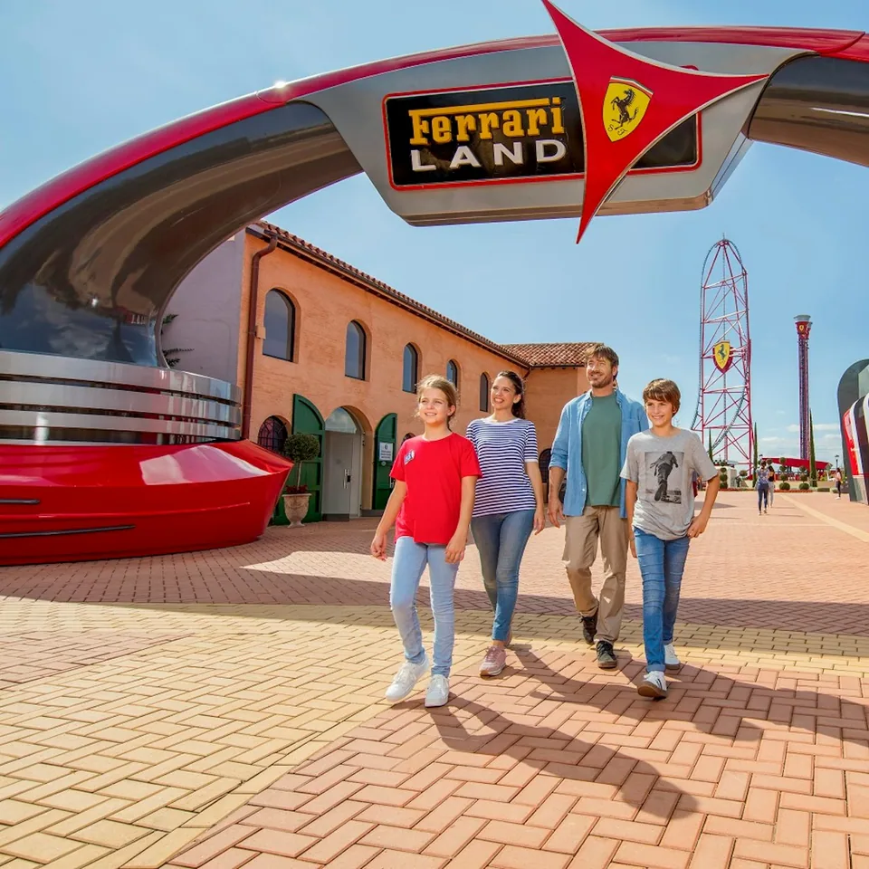 Visitors beneath the Ferrari Land entrance sign